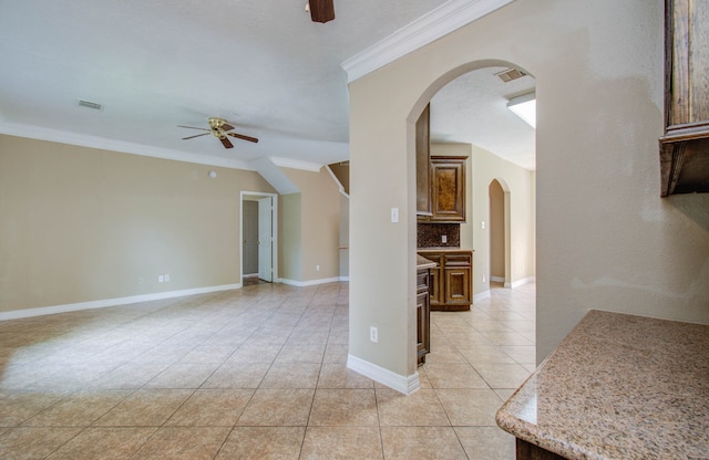 tiled spare room with ceiling fan and crown molding