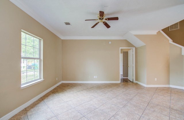 tiled empty room with ceiling fan and ornamental molding