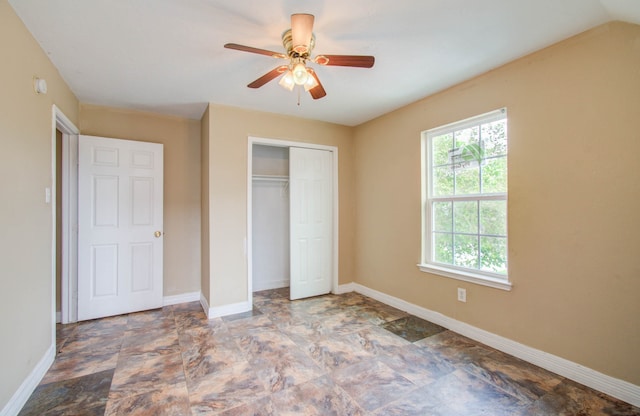 unfurnished bedroom with ceiling fan and a closet