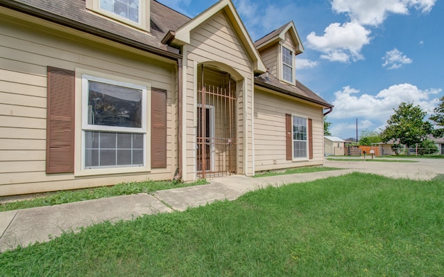 property entrance with a lawn