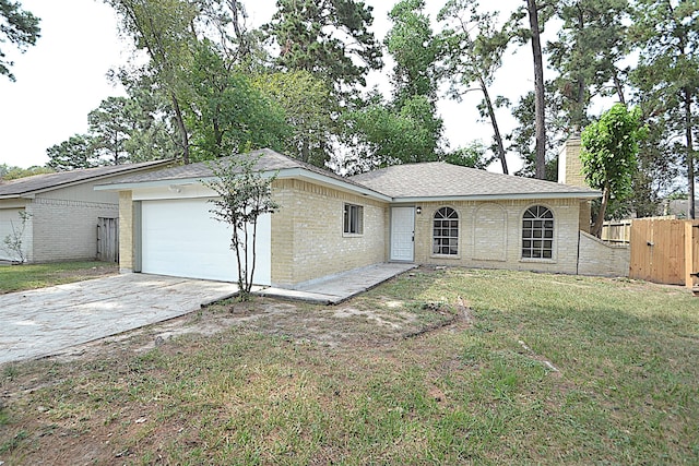 ranch-style home with a front lawn and a garage