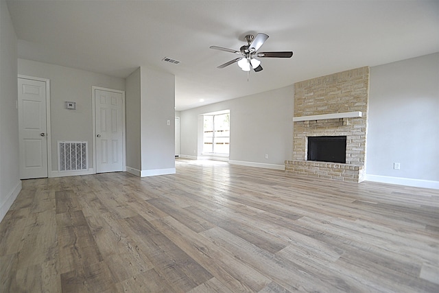 unfurnished living room with light wood-type flooring, ceiling fan, and a fireplace