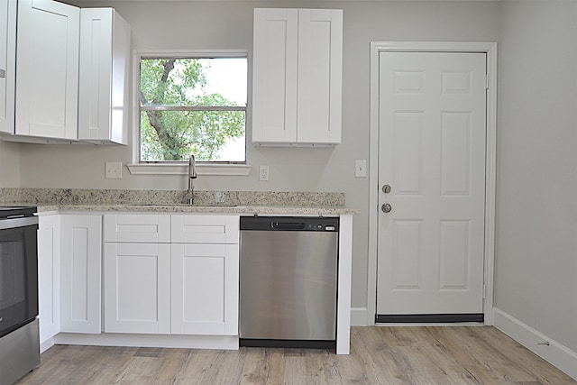 kitchen featuring white cabinets, stainless steel appliances, and light hardwood / wood-style floors