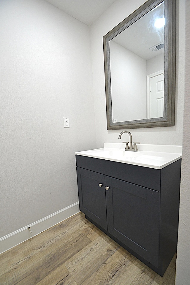 bathroom featuring vanity and hardwood / wood-style floors