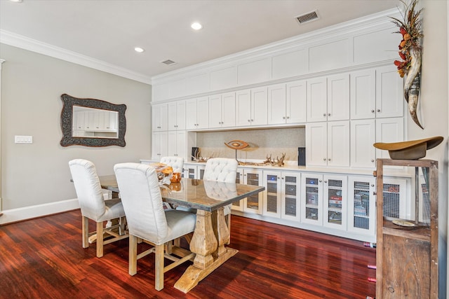 dining area featuring crown molding and dark hardwood / wood-style flooring