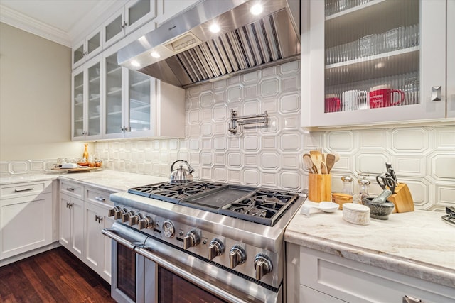 kitchen with white cabinetry, high end stainless steel range oven, crown molding, dark hardwood / wood-style floors, and extractor fan