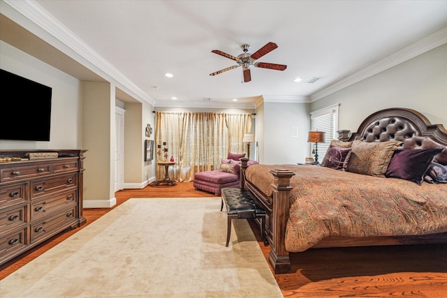 bedroom featuring ornamental molding, ceiling fan, and light hardwood / wood-style flooring