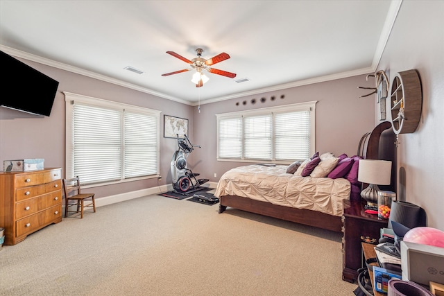 carpeted bedroom with ornamental molding and ceiling fan