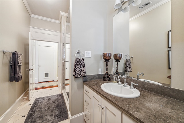 bathroom with ornamental molding, vanity, and tile patterned flooring