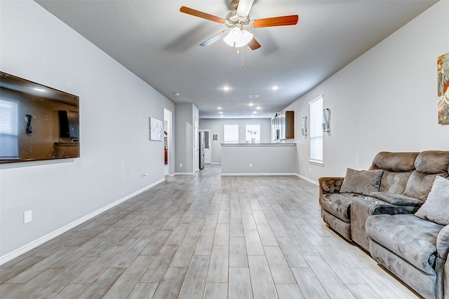 unfurnished living room with ceiling fan and light hardwood / wood-style flooring