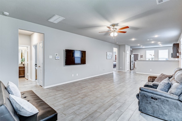 living room featuring light wood-type flooring and ceiling fan