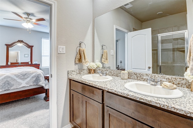 bathroom featuring ceiling fan, a shower with door, and vanity