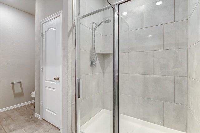 bathroom with walk in shower and toilet