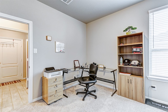 office area featuring light colored carpet