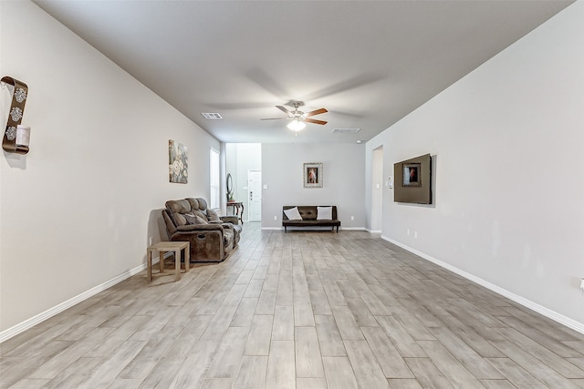 sitting room featuring light wood-type flooring and ceiling fan