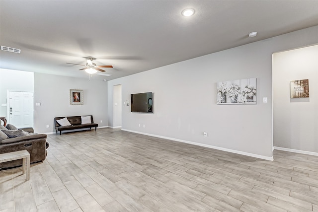 living room with light hardwood / wood-style floors and ceiling fan