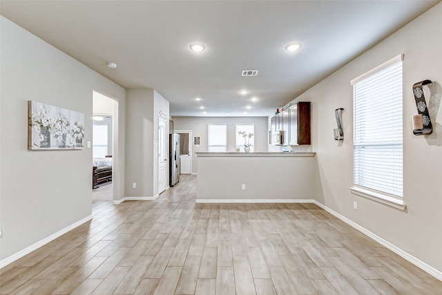 unfurnished living room featuring light hardwood / wood-style flooring