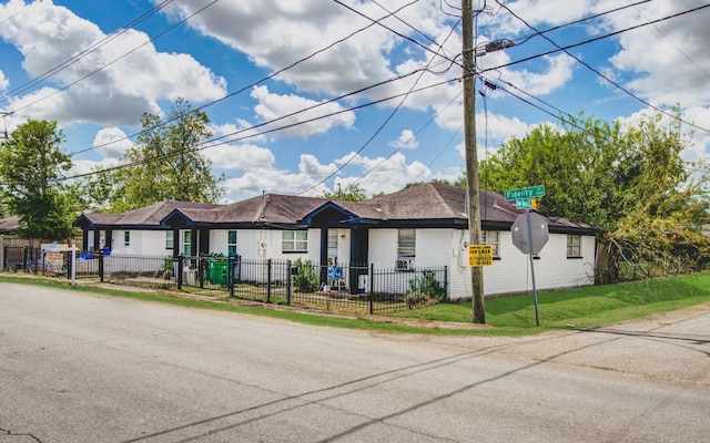 ranch-style house with a fenced front yard and a front yard