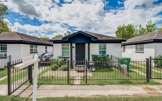 bungalow-style home featuring a gate and a fenced front yard