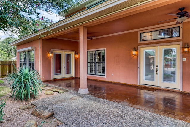 entrance to property featuring french doors, a patio area, and ceiling fan