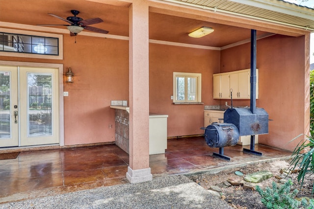 view of exterior entry featuring a patio and ceiling fan