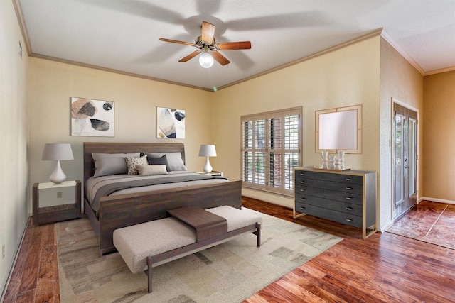 bedroom with crown molding, wood-type flooring, and ceiling fan