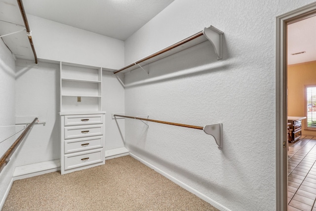 spacious closet featuring light carpet