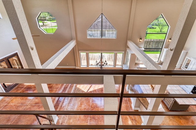 stairway with a towering ceiling and plenty of natural light