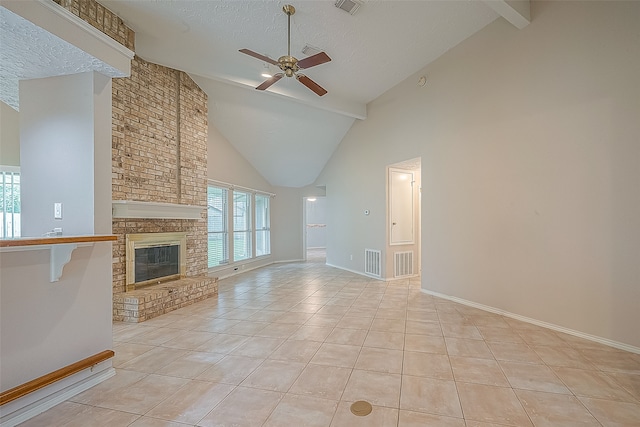 unfurnished living room featuring ceiling fan, light tile patterned floors, a textured ceiling, high vaulted ceiling, and a fireplace