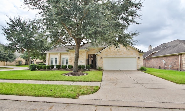 view of front facade with a front yard and a garage