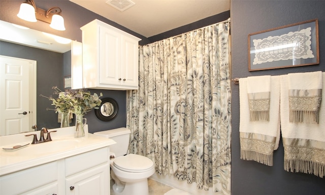 bathroom with walk in shower, tile patterned floors, vanity, and toilet