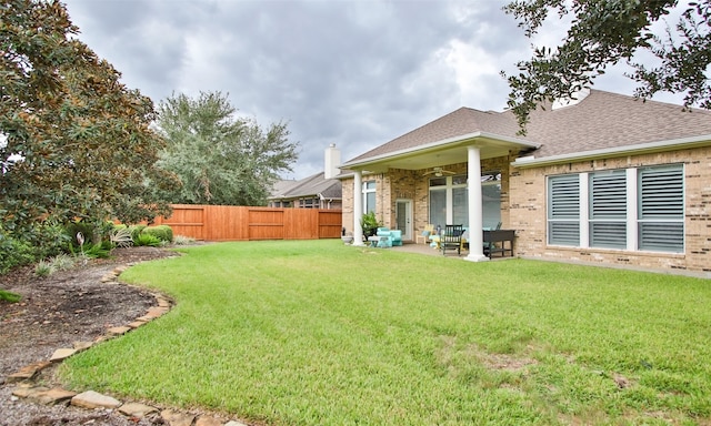 view of yard with a patio and ceiling fan