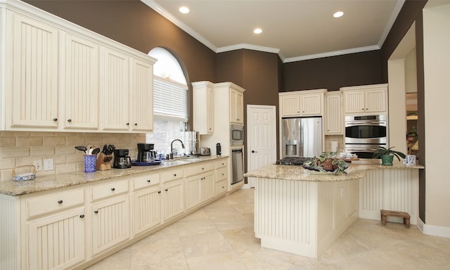 kitchen featuring light stone countertops, crown molding, sink, and stainless steel appliances