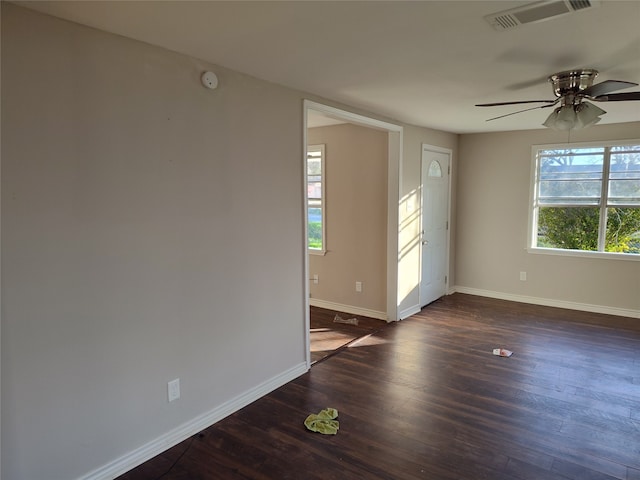 unfurnished room with ceiling fan and dark hardwood / wood-style flooring