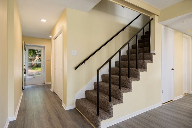 stairs with wood-type flooring