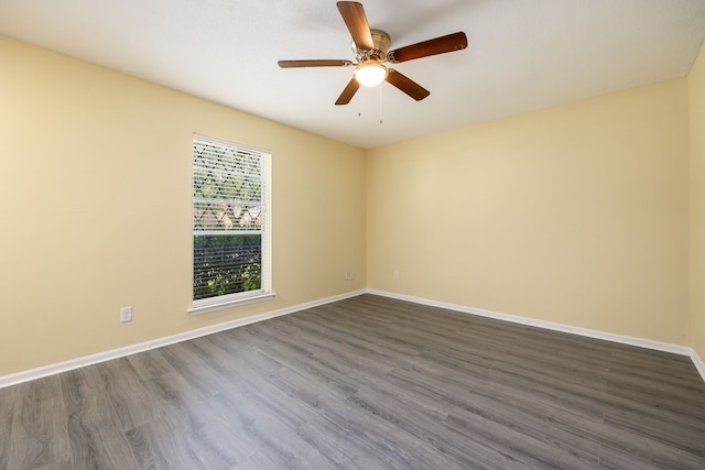 spare room featuring ceiling fan and dark hardwood / wood-style floors