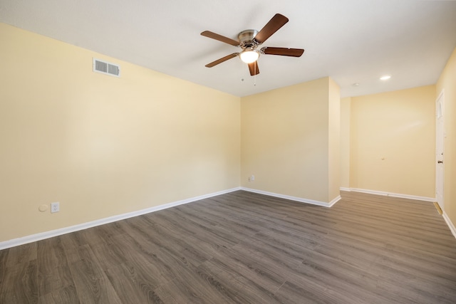 empty room featuring dark hardwood / wood-style floors and ceiling fan