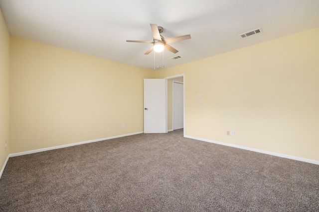 carpeted spare room featuring ceiling fan