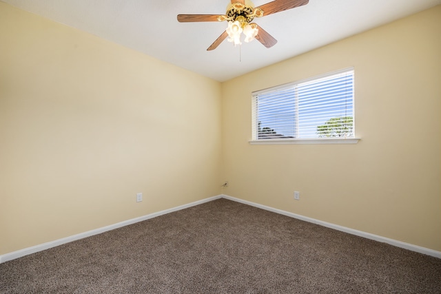 carpeted spare room featuring ceiling fan