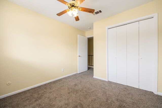 unfurnished bedroom with ceiling fan, carpet floors, and a closet