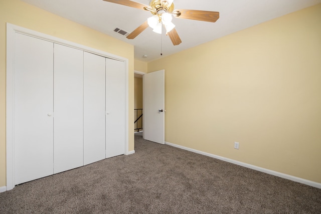 unfurnished bedroom featuring carpet, ceiling fan, and a closet