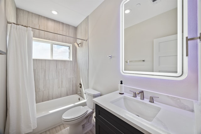 full bathroom with shower / tub combo, vanity, and toilet