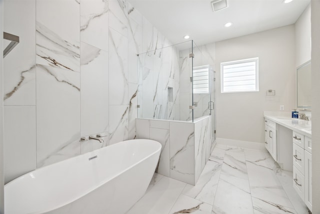 bathroom with vanity and shower with separate bathtub