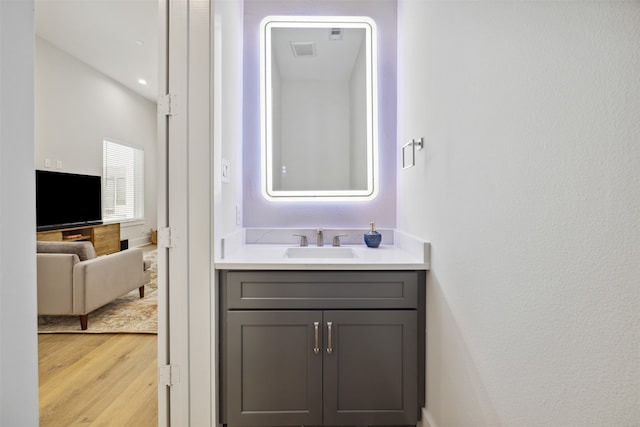 bathroom with vanity and hardwood / wood-style floors