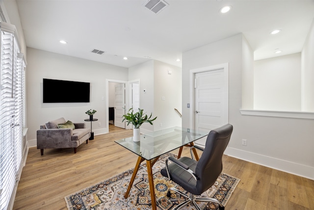 office space with light hardwood / wood-style flooring