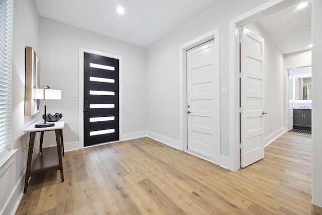 foyer entrance with light hardwood / wood-style flooring