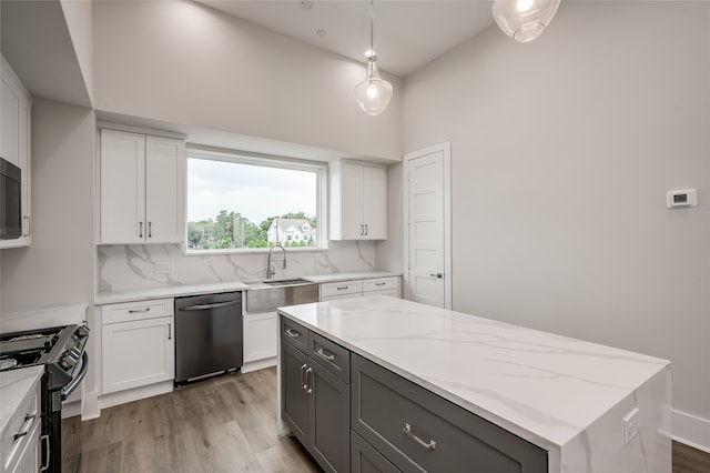 kitchen with white cabinets, pendant lighting, stainless steel appliances, a center island, and decorative backsplash