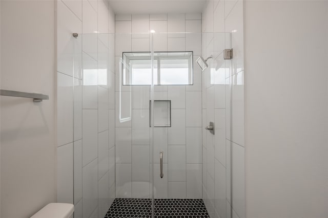 bathroom with walk in shower and toilet