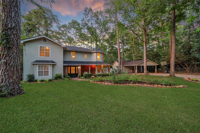 view of front of property with a yard and covered porch