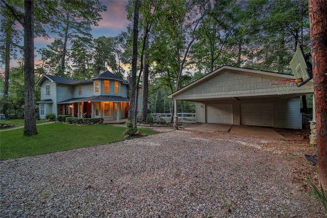 view of front of property with a yard, covered porch, and a carport